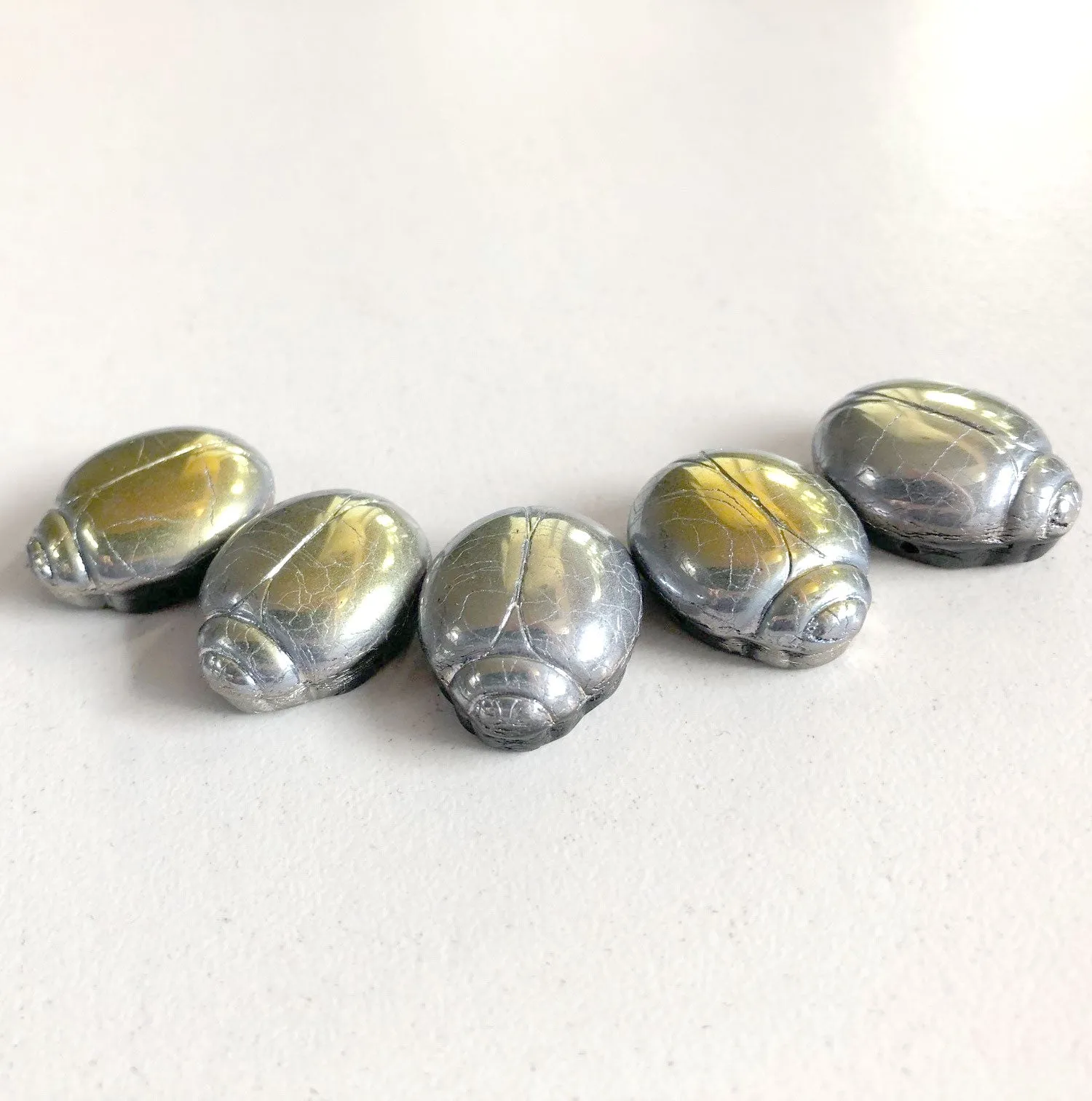2-hole glass scarab bead with iridescent Marea crackle finish.  20x16x8mm. Pkg. 1.  b11-mi-2072